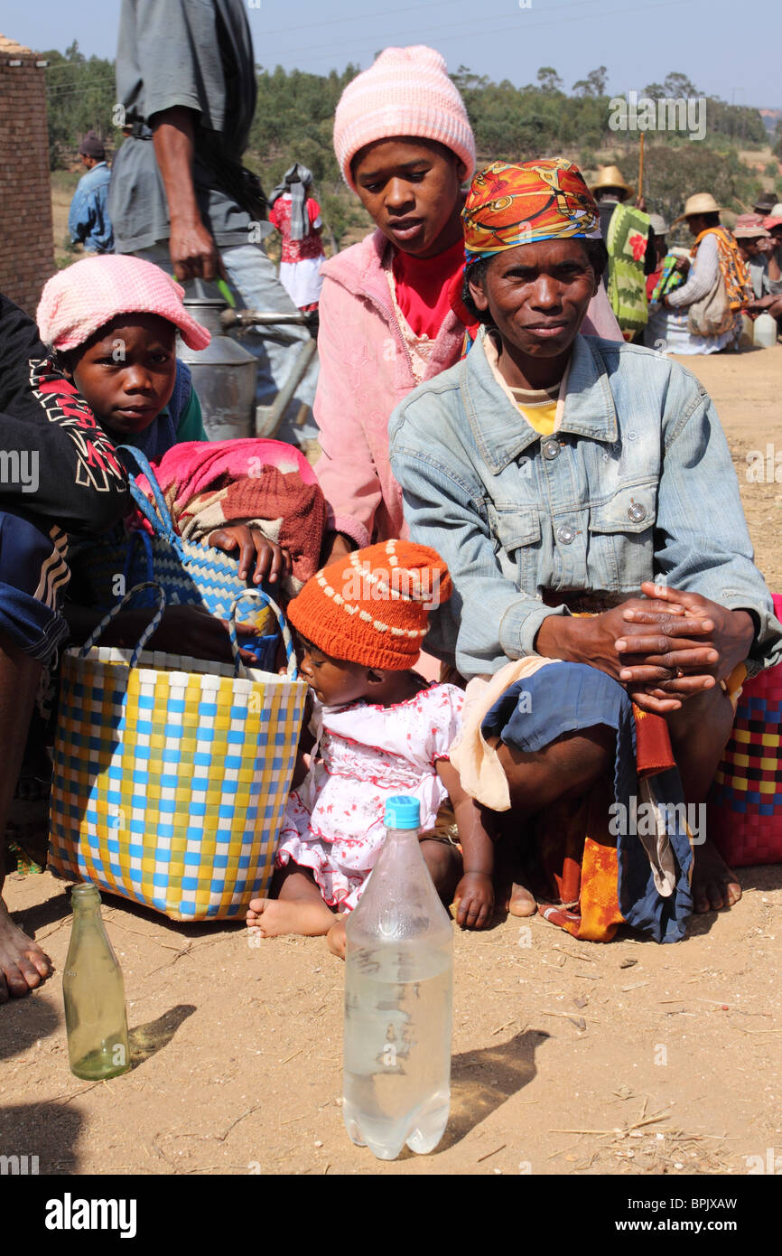 Malagasy family selling rum at a rural market, Madagascar Stock Photo