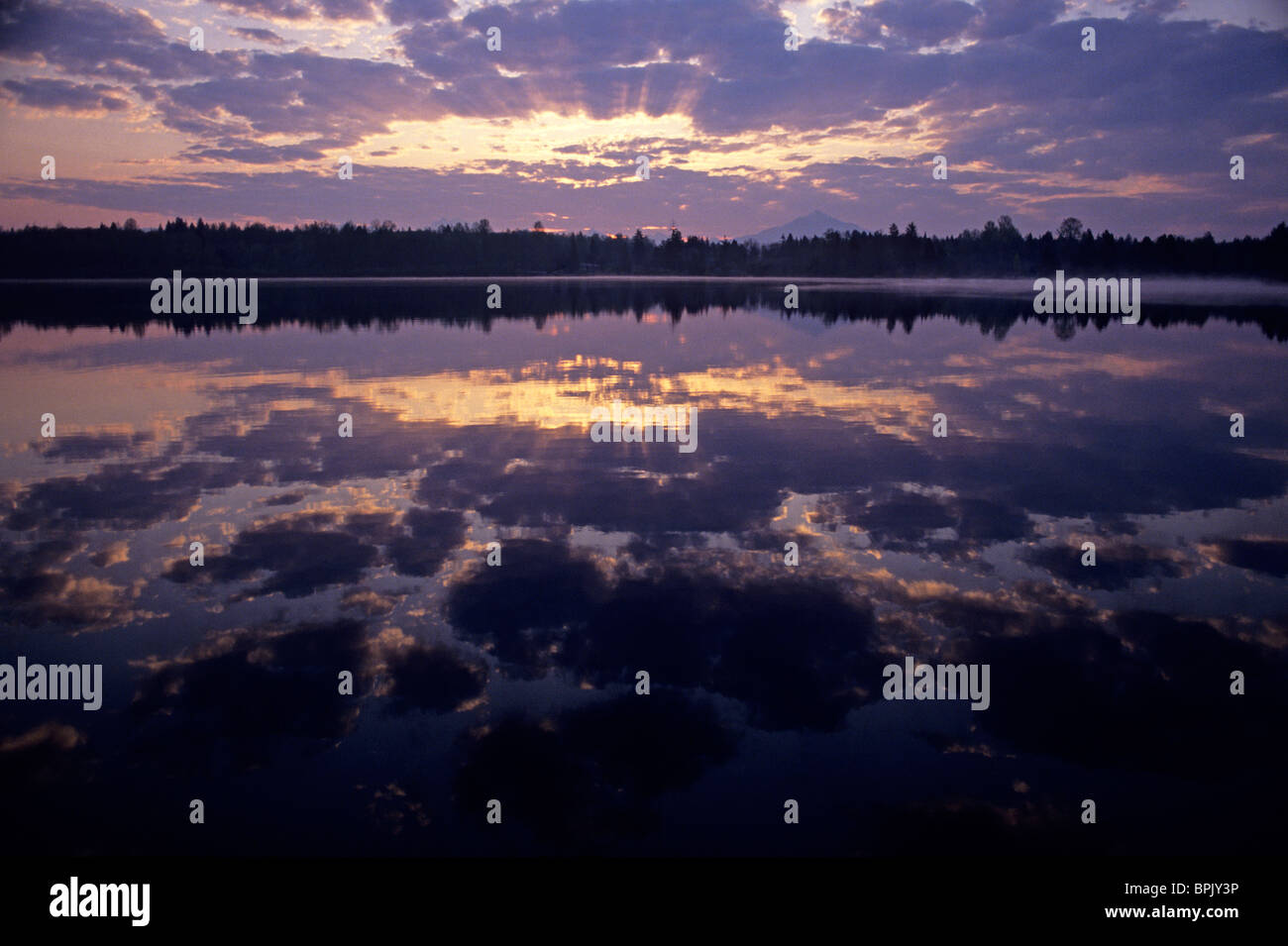 Sunrise at Lake Cassidy with dramatic clouds and Mount Pilchuck