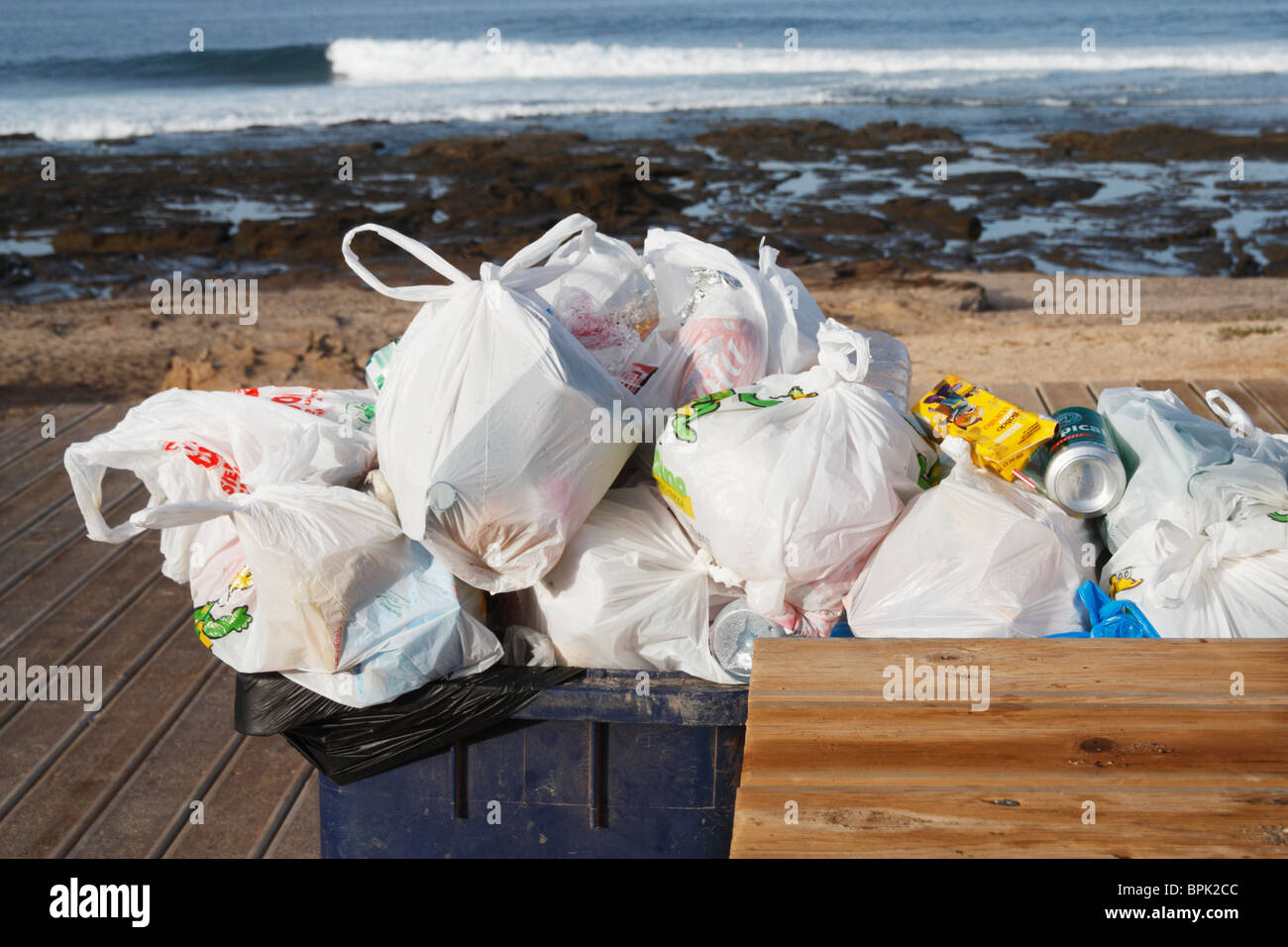 Overflowing wheelie bin on beach in Spain Stock Photo - Alamy