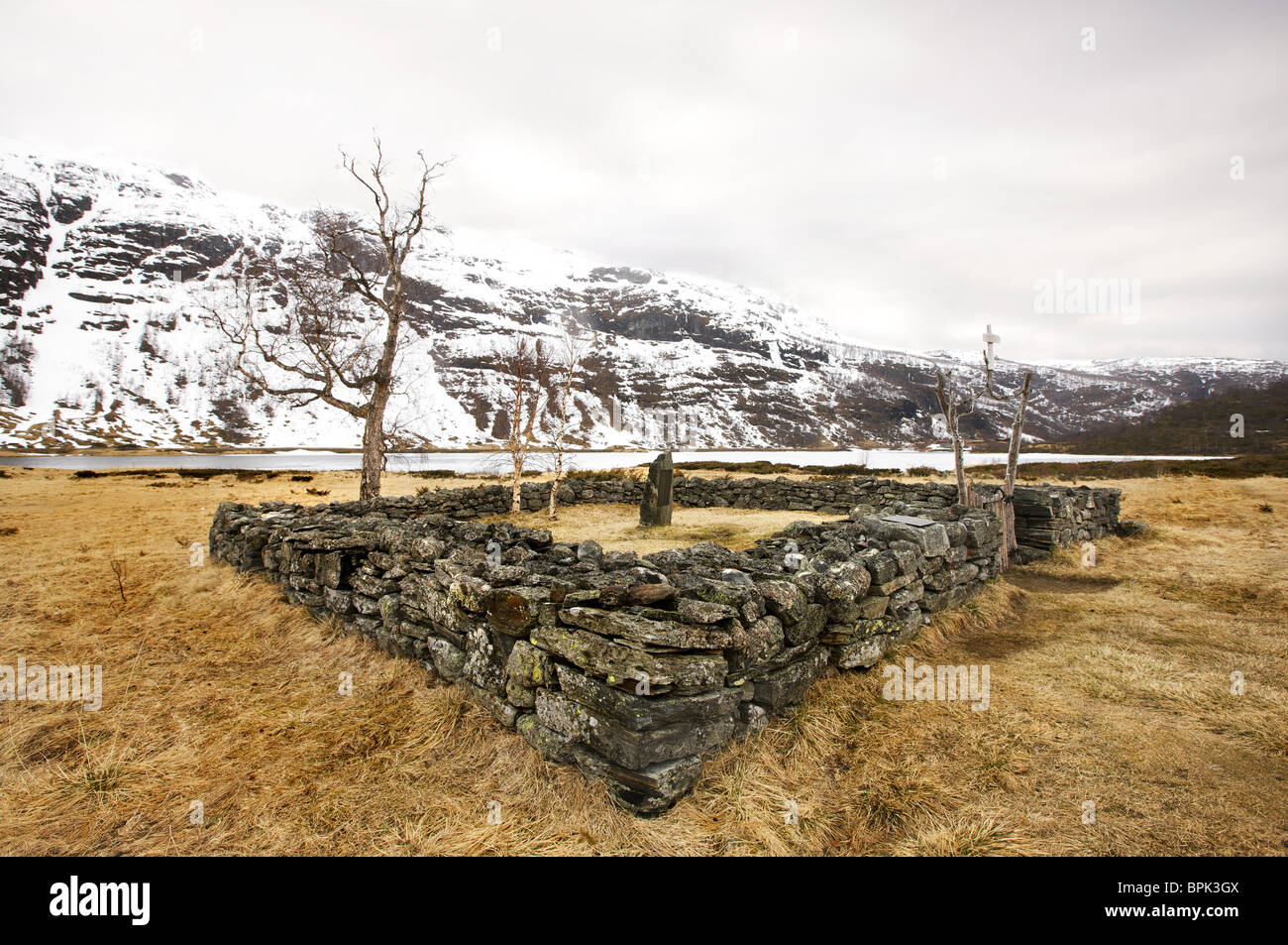 Old gravesite in front of snow covered mountains, Aurlandsdalen, Aurland, Sogn og Fjordane, Norway, Scandinavia, Europe Stock Photo