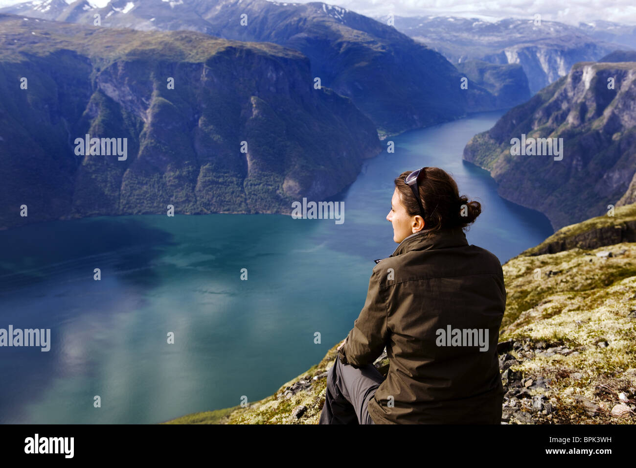 Young woman looking at the Aurlandsfjord, Prest, Aurland, Sogn og Fjordane, Norway, Scandinavia, Europe Stock Photo