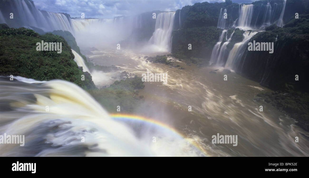 Brazil, Igwacu Falls, A rainbow arches through Igwacu Falls in Brazil. Stock Photo