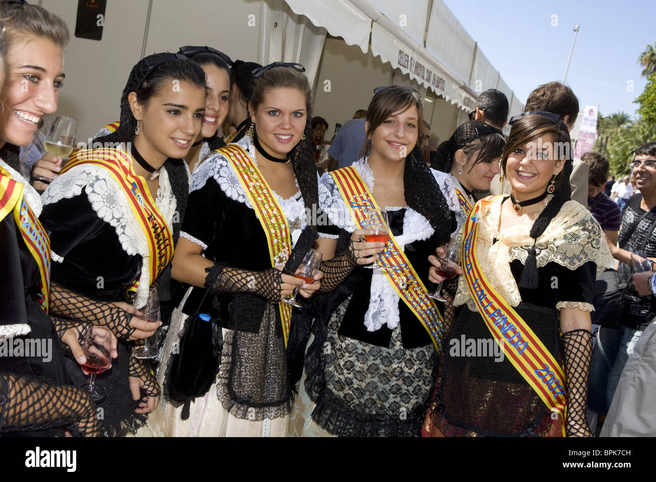 Young women in traditional costumes sampling wines, Sitges, Catalonia, Spain, Europe Stock Photo