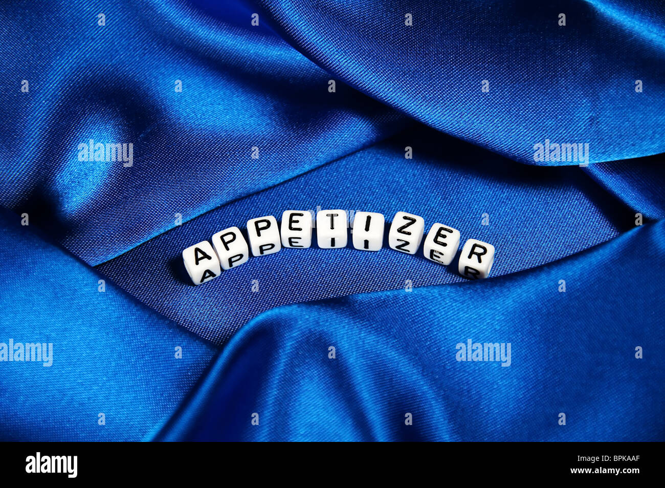 This series has a deep royal blue satin shiny background with the word Appetizer in black and white cube lettering. Stock Photo