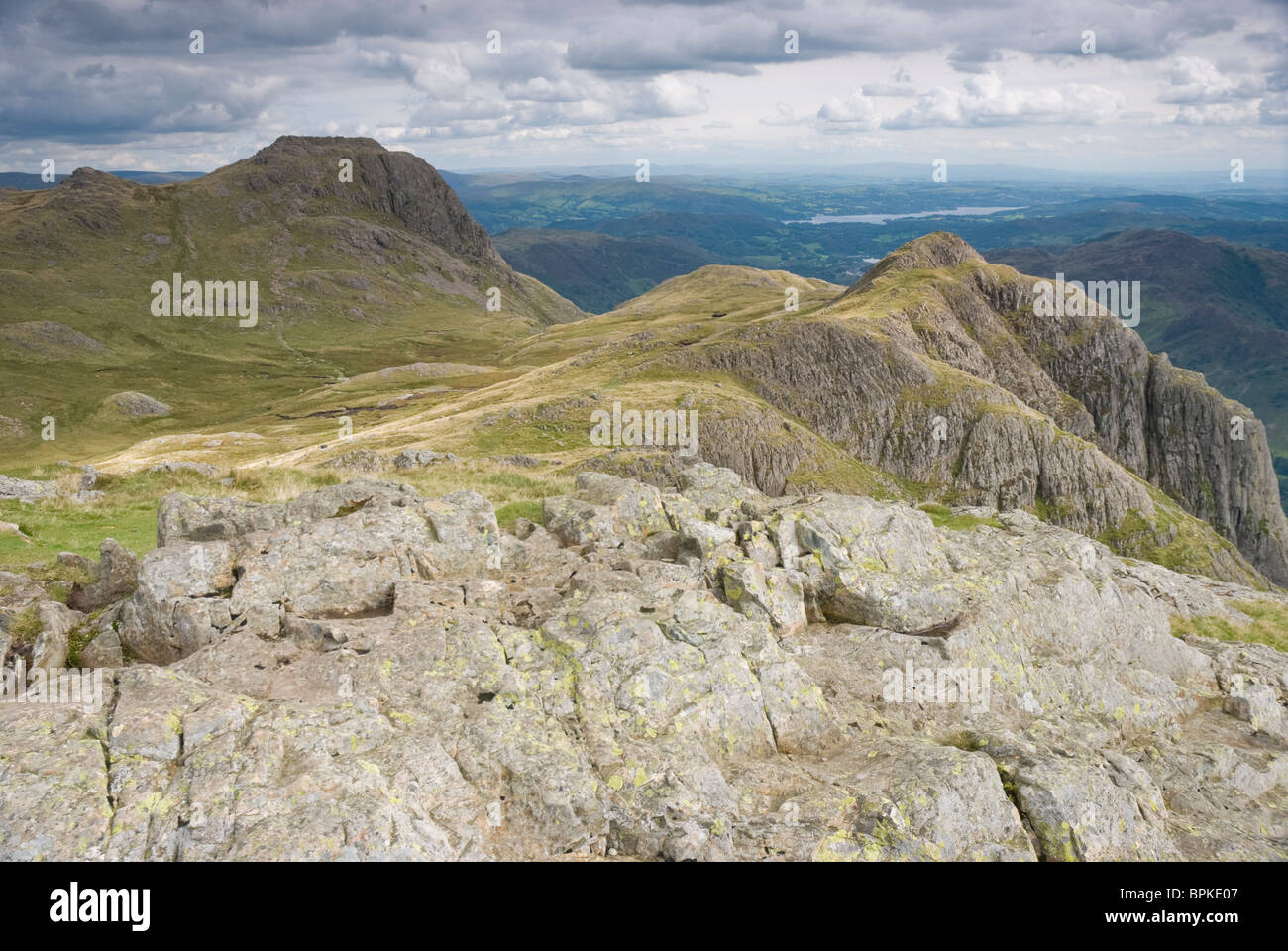 The Langdale Pikes of Loft Crag and Harrison Stickle, from Pike O'Stickle, with Windermere beyond. Stock Photo