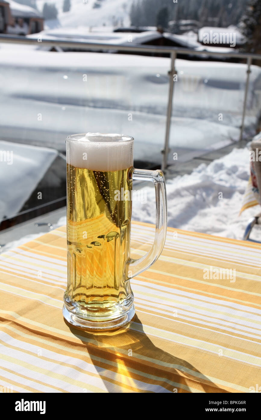 Cold beer served outside in the snow in Murren Stock Photo