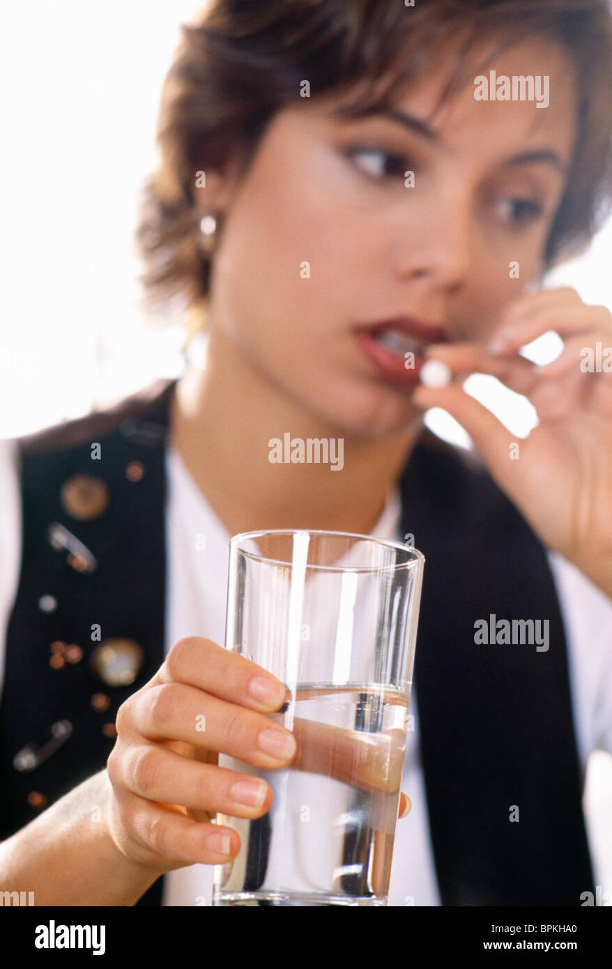 Adult Woman Taking Pill with Water Stock Photo