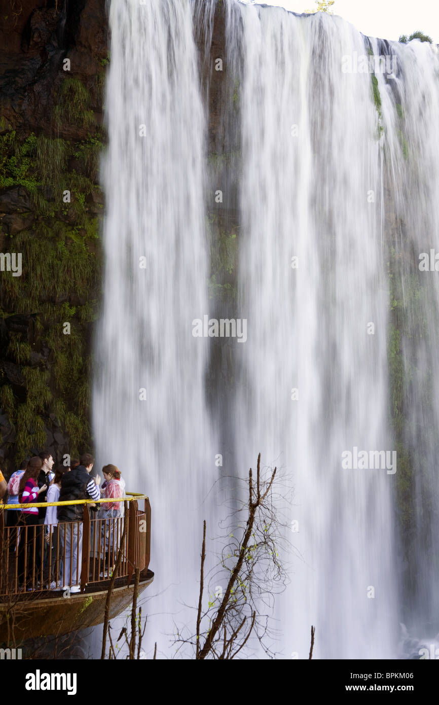 Visitors watching Iguazu falls in the Brazil side of the falls. Stock Photo