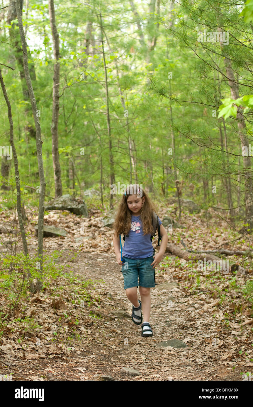 Eight year old girl takes a walk in the woods Stock Photo - Alamy