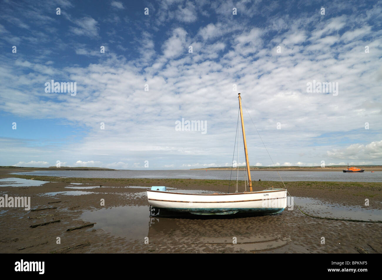 Beached sailing boat with outboard engine Stock Photo