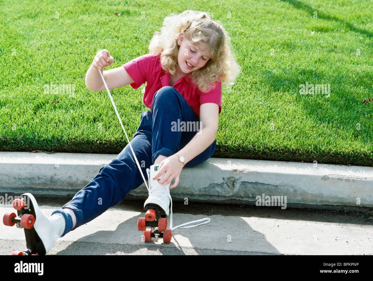 Teenage Girl Lacing Up Roller Skates, United States 1980s Stock Photo