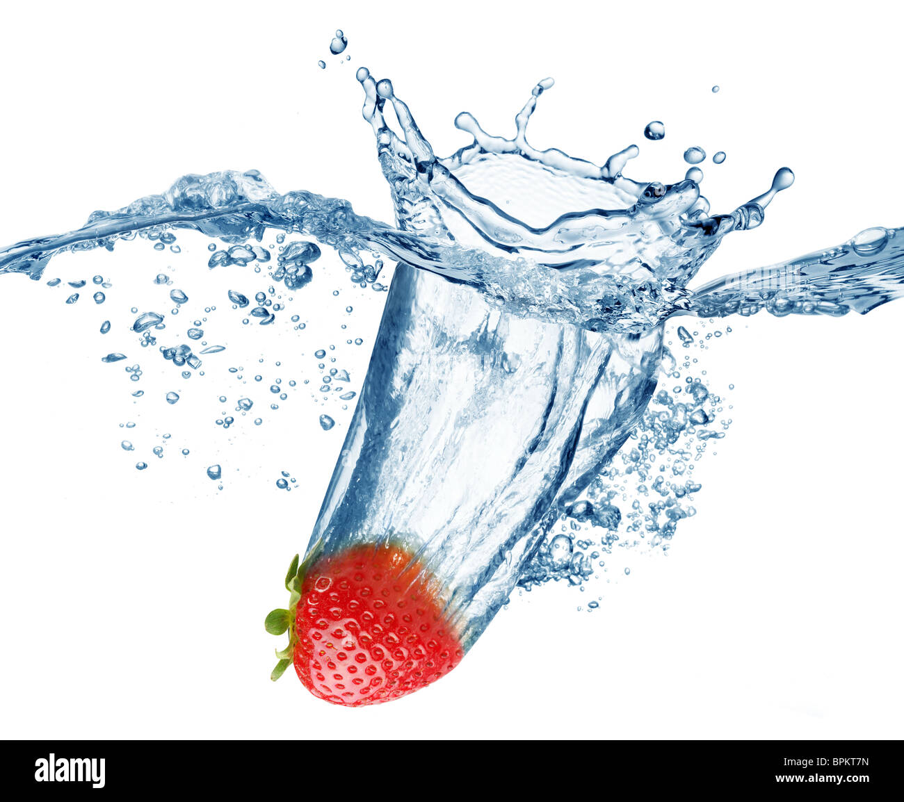 Strawberry falls deeply under water with a big splash. Stock Photo