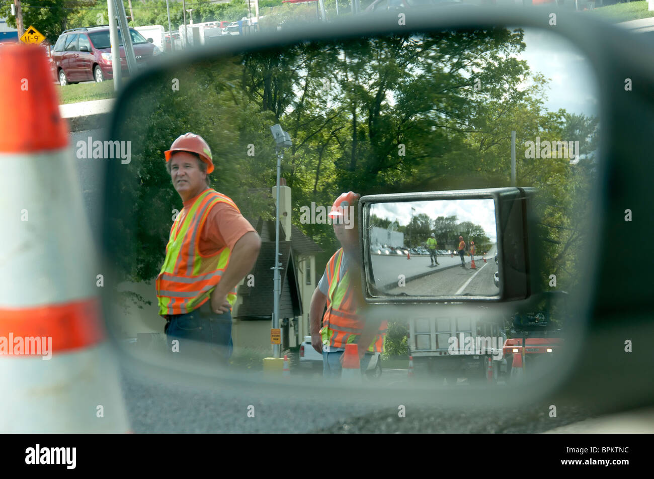 Road work crew seen in side view mirror. Stock Photo
