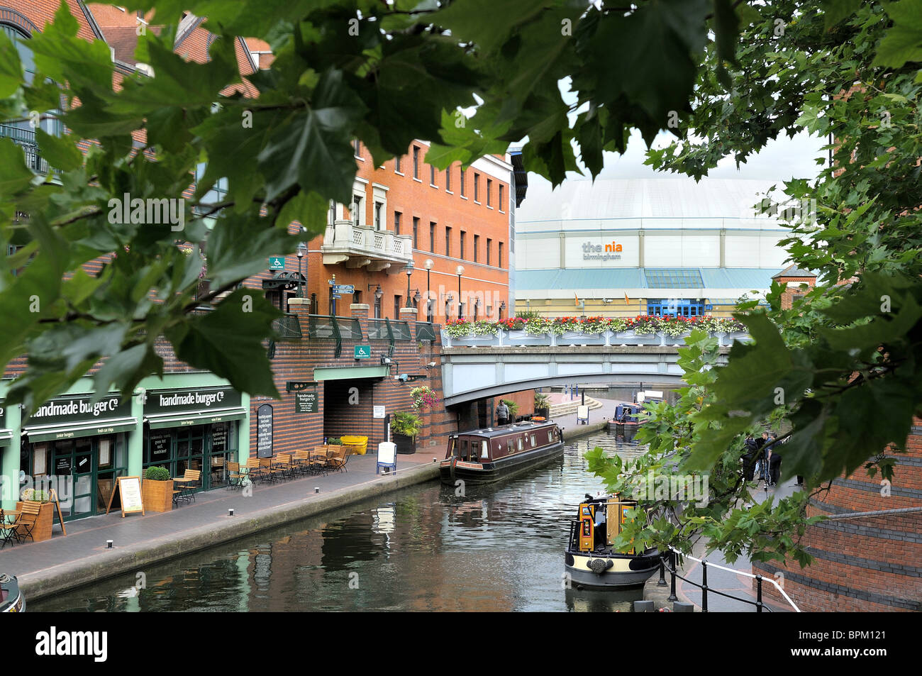 The canal at Brindley Place with the National Indoor Arena in the background, Birmingham. Stock Photo