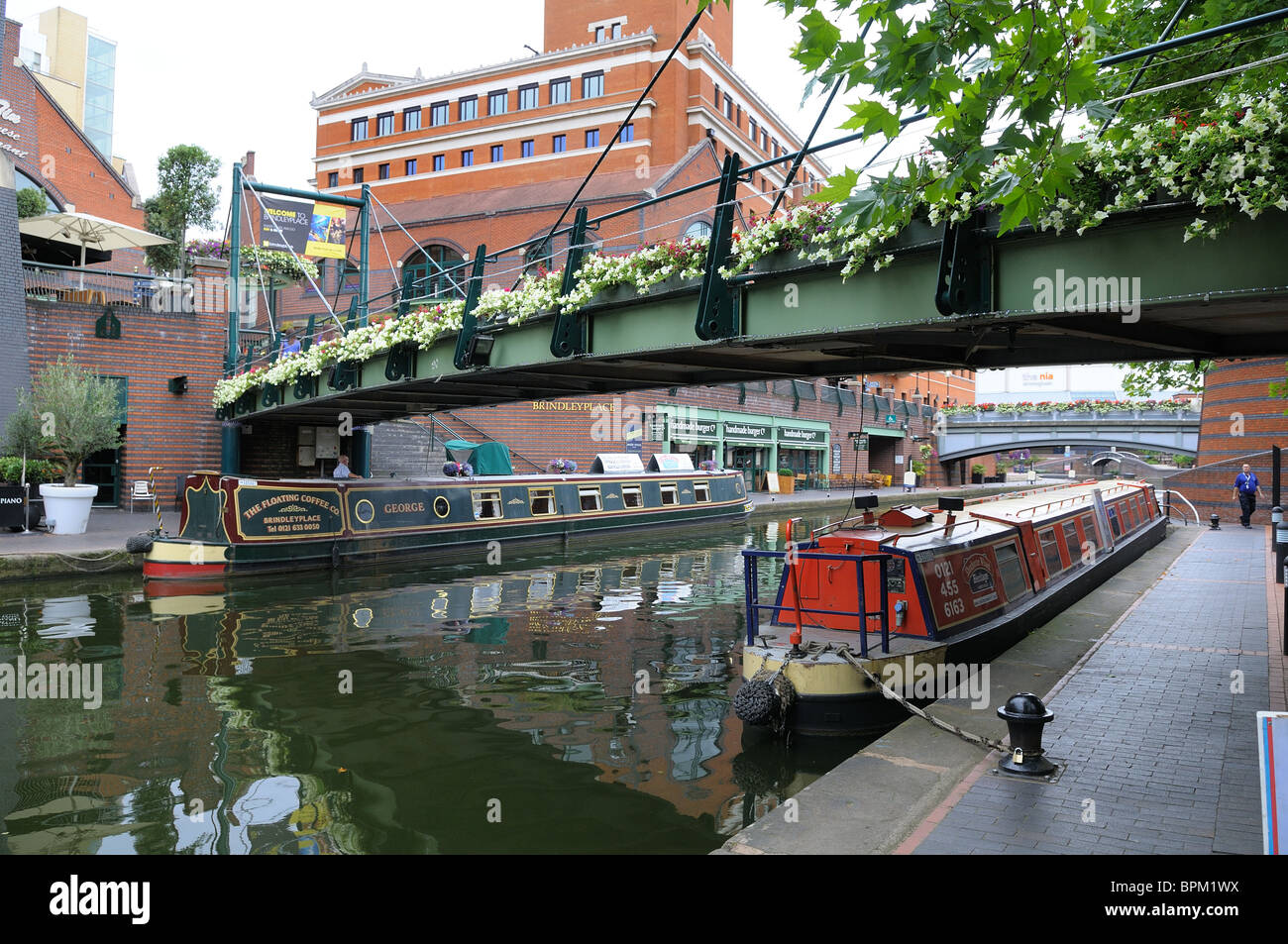 Birmingham canal passing under footbridge between Brindley Place and the International Convention Centre. Stock Photo