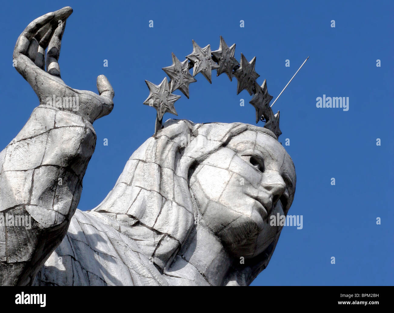 Ecuador, Quito. The Virgin of Panecillo watches over the capitol of Ecuador against a blue sky. Stock Photo