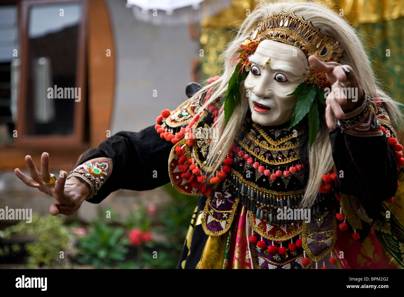 A masked dancer in a Balinese street dance ceremony Stock Photo