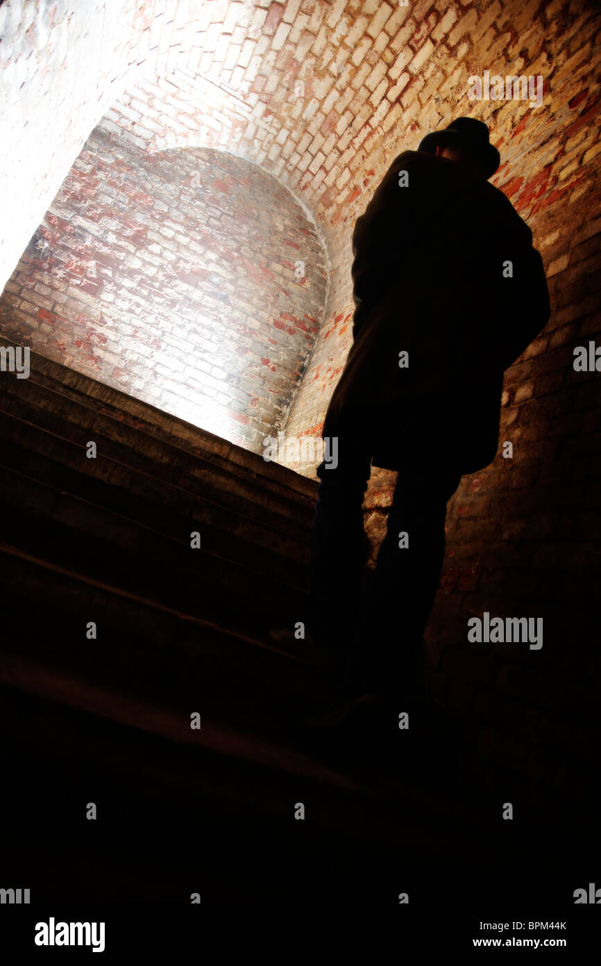 Man walking up Stairs in Tunnel Stock Photo