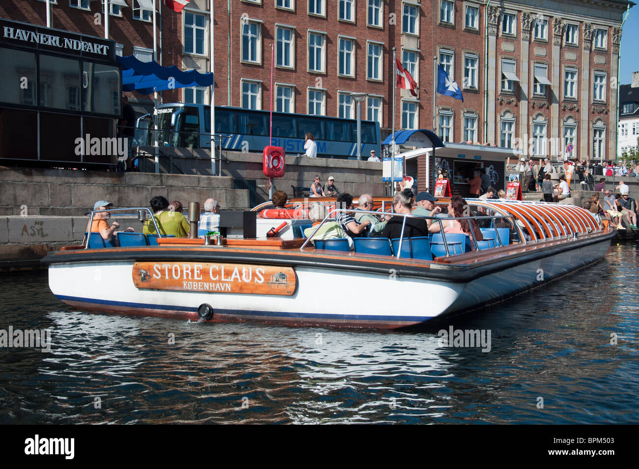 A view of the buildings and a canal cruise boat on the Nyhavn canal in Copenhagen, Denmark. Stock Photo