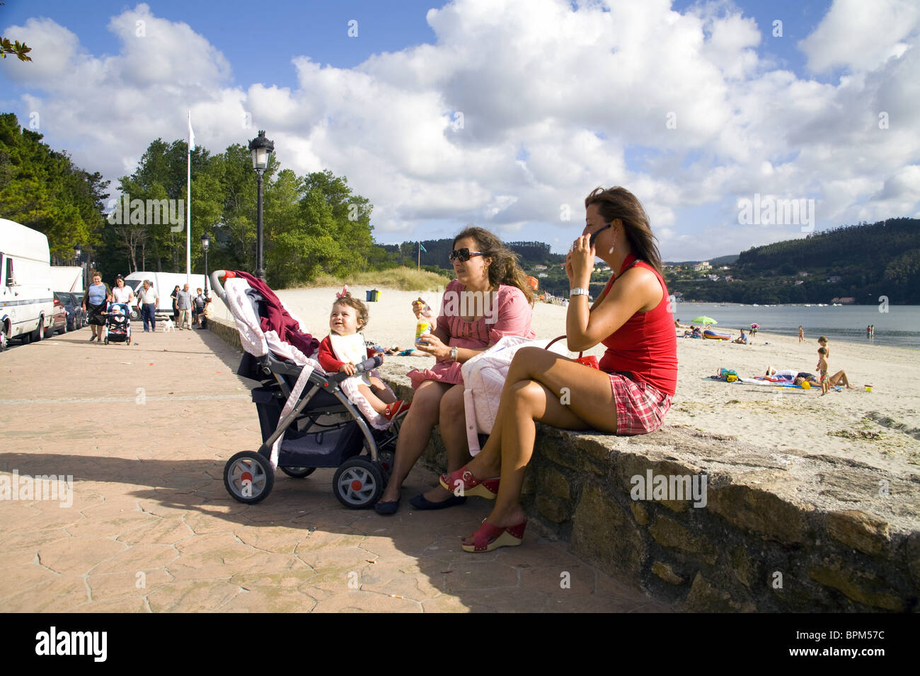 Women chatting beside the beach in Cedeira, A Coruña, Spain Stock Photo