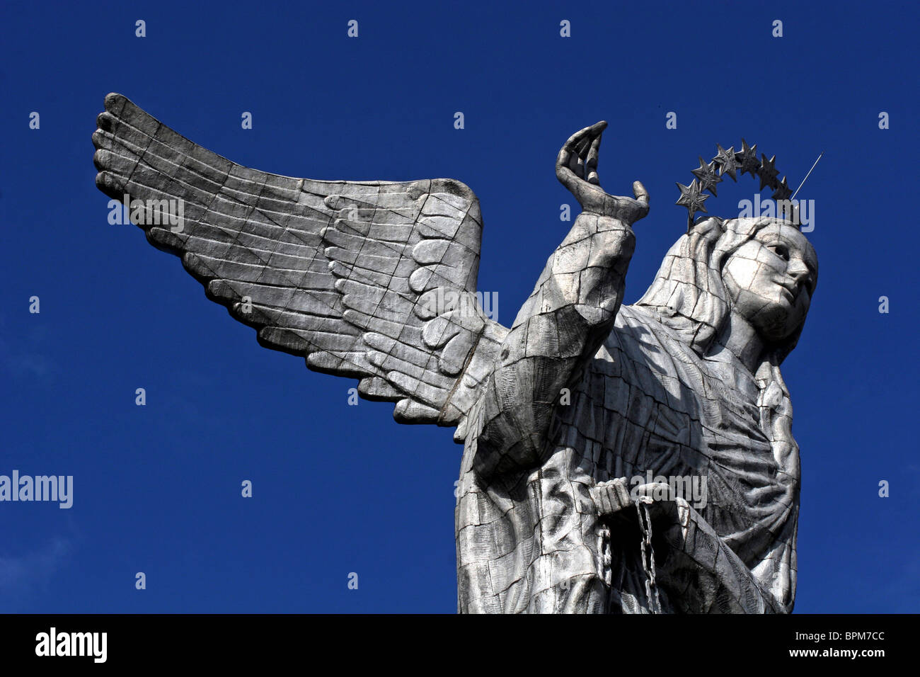 Ecuador, Quito. The Virgin of Panecillo watches over the capitol of Ecuador against a blue sky. Stock Photo