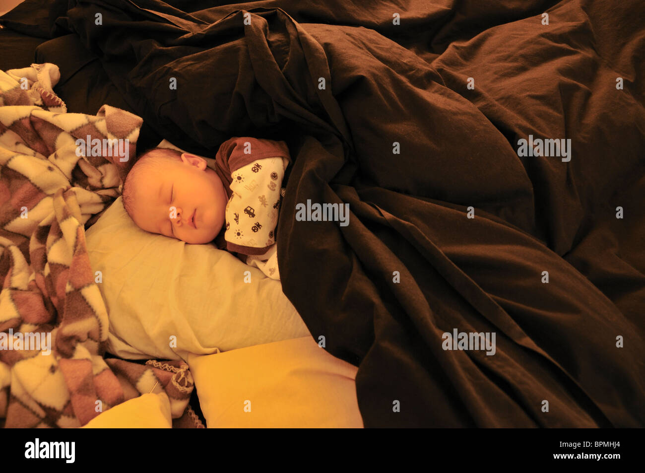 Two months old baby sleeping in a big bed Stock Photo Alamy