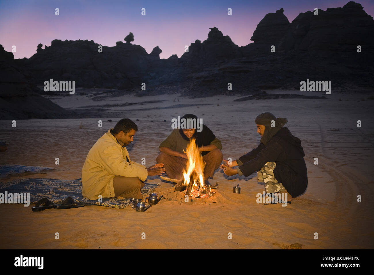 Tuaregs drinking tea at campfire, Tassili Maridet, Libya, Sahara, Africa Stock Photo