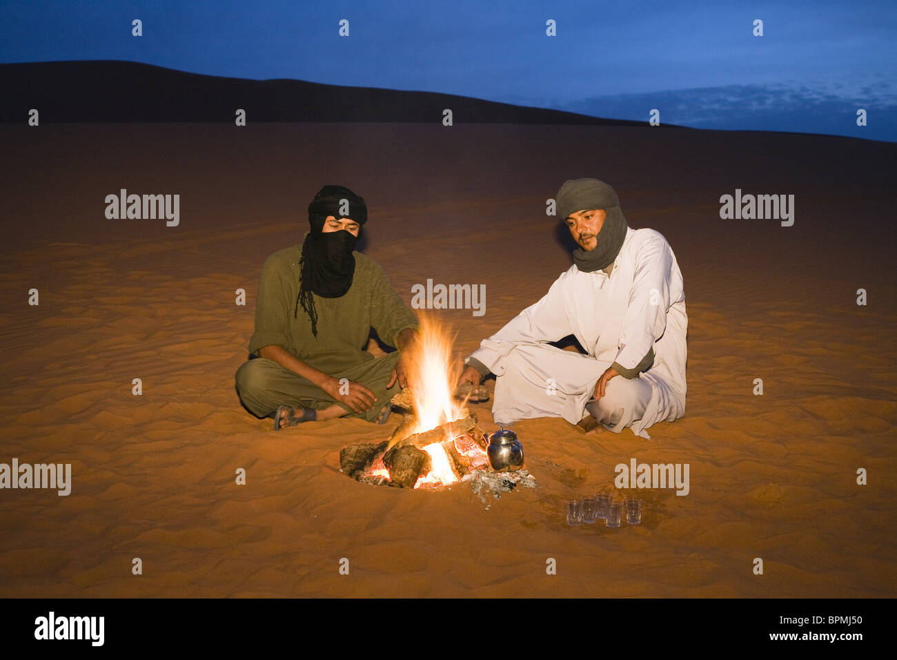 tuaregs preparing tea at campfire, Libya, Africa Stock Photo