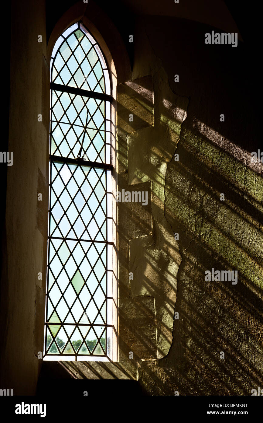 Sunlight streaming through the stained glass window at St George's Church, Burrington, Herefordshire Stock Photo
