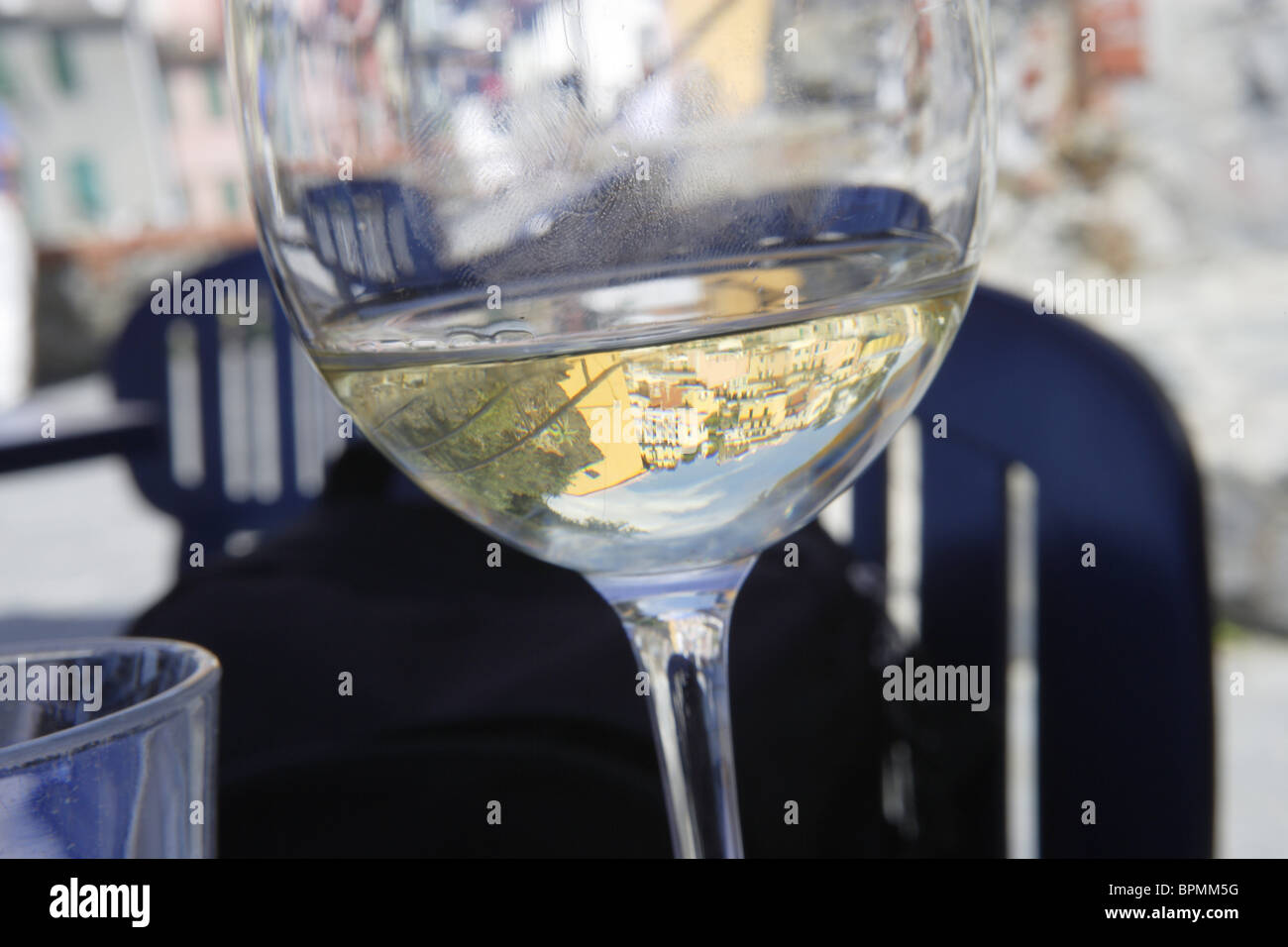 Reflection in a glass of white wine, Riomaggiore, Cinque terre, Liguria, Italy Stock Photo
