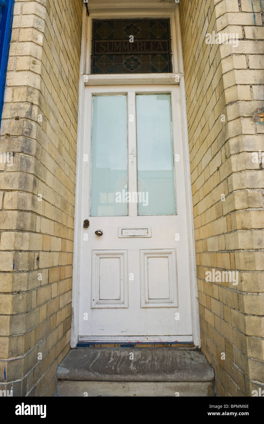 Victorian wooden paneled and glazed white painted front door of brick built house in Llandrindod Wells Powys Mid Wales UK Stock Photo