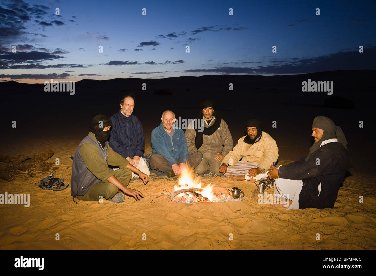 tuaregs with tourists at campfire, Libya, Africa Stock Photo