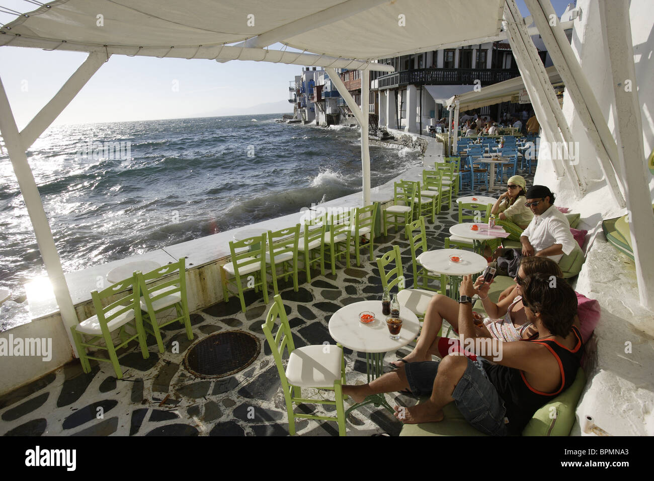 People on the terrace of a bar, Little Venice, Mykonos Town, Greece, Europe Stock Photo