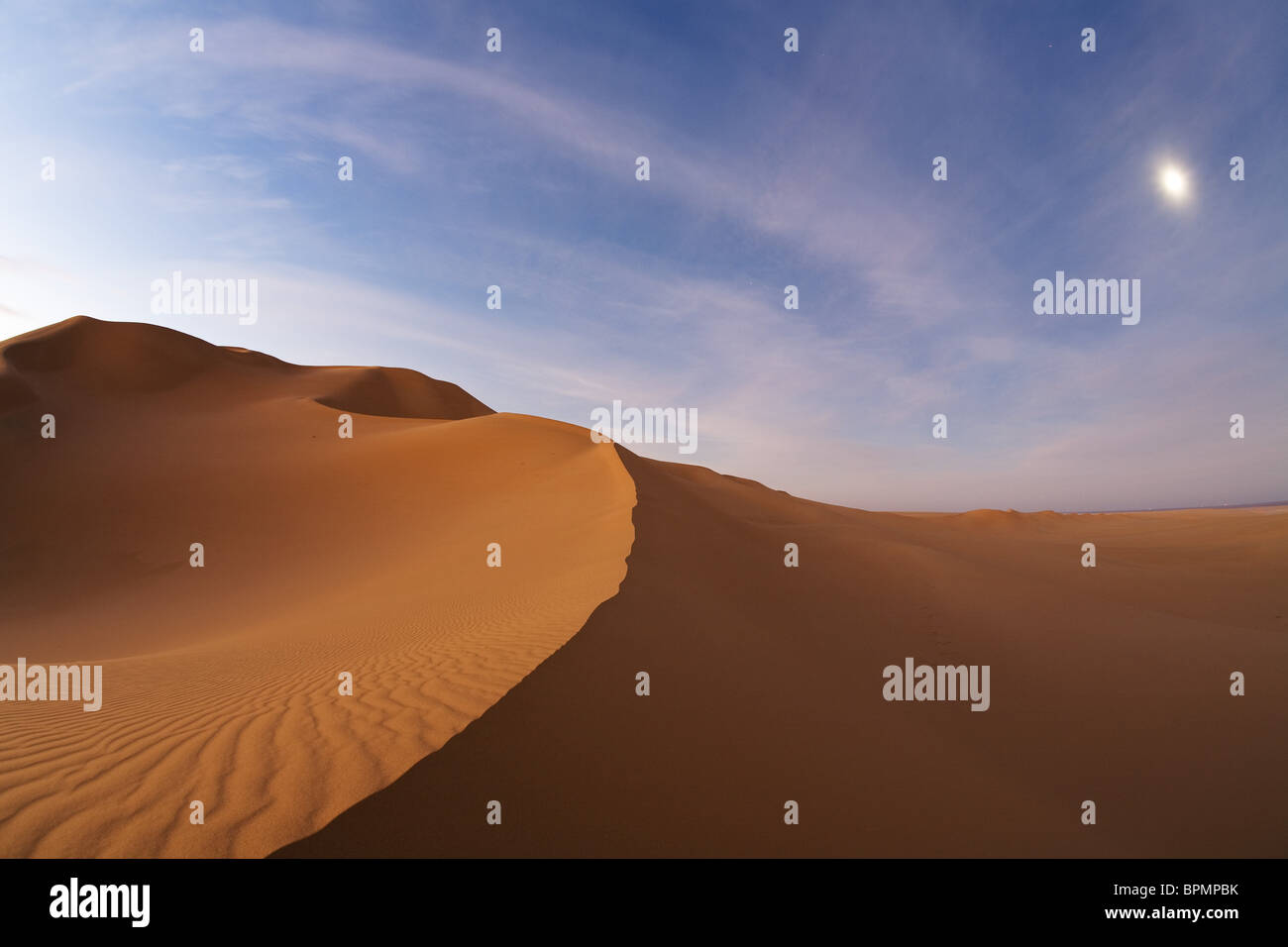 Sanddunes in the libyan desert with moon at dawn, Sahara, Libya, North Africa Stock Photo