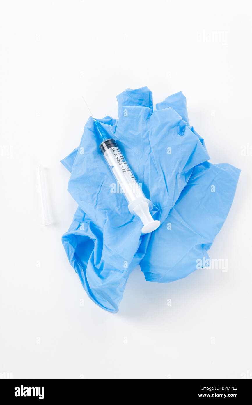 Medical Glove and needle with white background, Medical Waste Stock Photo