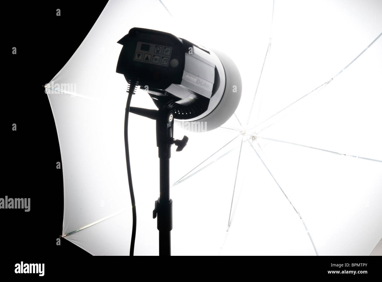 Compact studio lighting unit with white shoot-through umbrella Stock Photo
