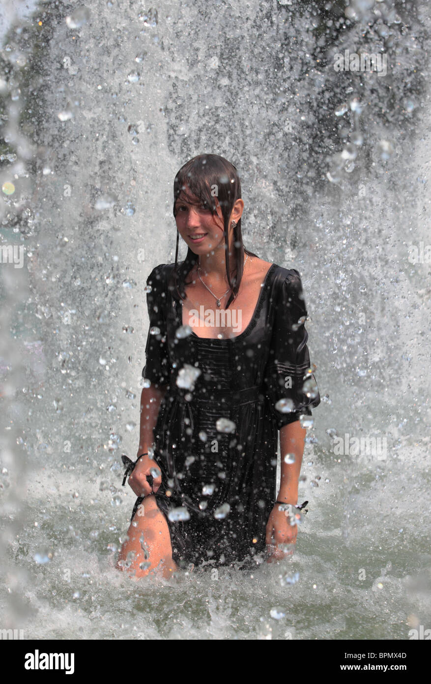 Pretty girl refreshing in water jets, Russian hot summer 2010 Stock Photo