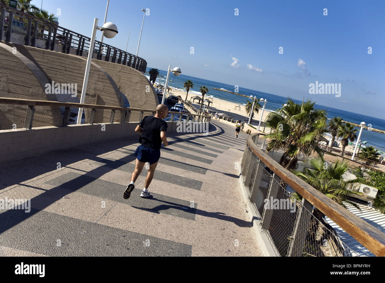 Jogger on the Tayelet seaside promenade, Gordon Beach, Tel Aviv, Israel, Middle East Stock Photo