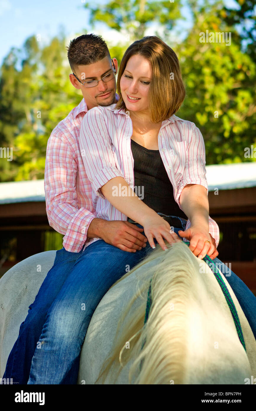couple riding a horse without saddle on the ranch, homestead romantic Stock Photo