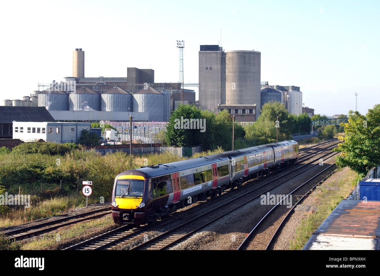 Arriva Cross Country train passing Molson Coors brewery, Burton on Trent, Staffordshire, England, UK Stock Photo