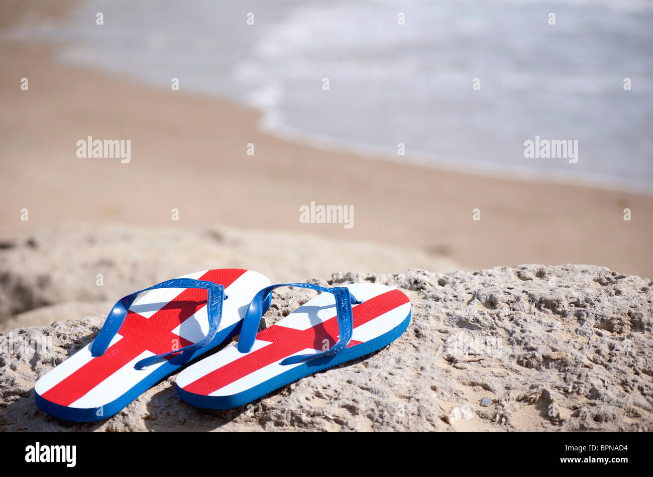 British Tourist - England flip flops on a sunny beach Stock Photo - Alamy
