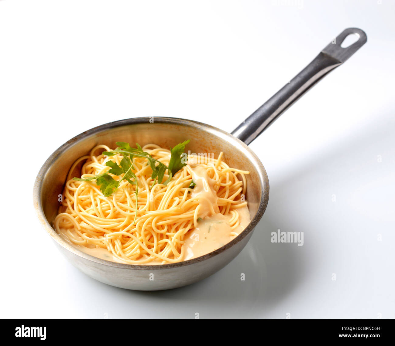 Spaghetti and cheese sauce in a saucepan Stock Photo