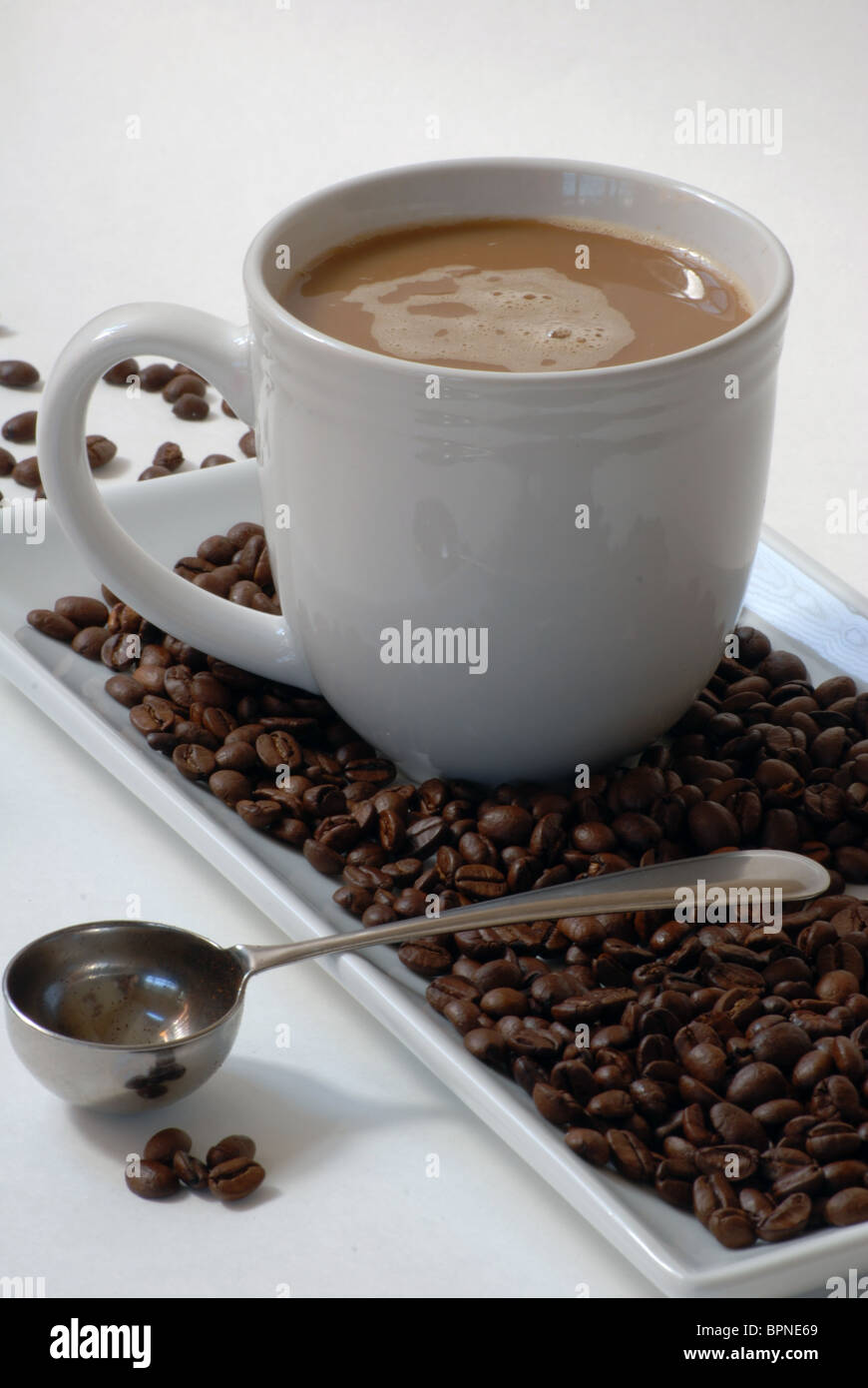 Coffee with cream, coffee beans, measuring spoon Stock Photo Alamy