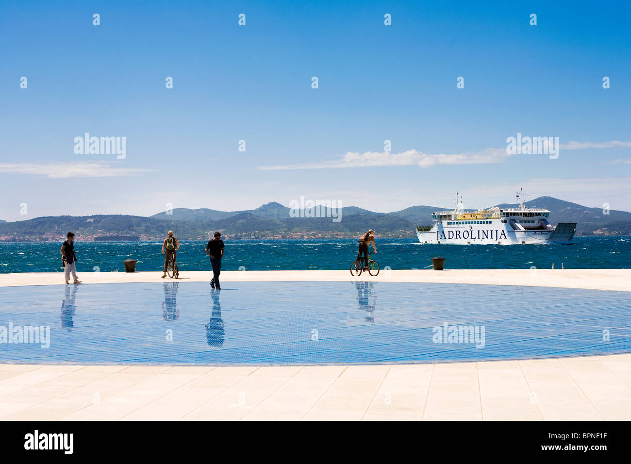 People walking along the front at Zadar to enjoy the sea breeze Stock Photo