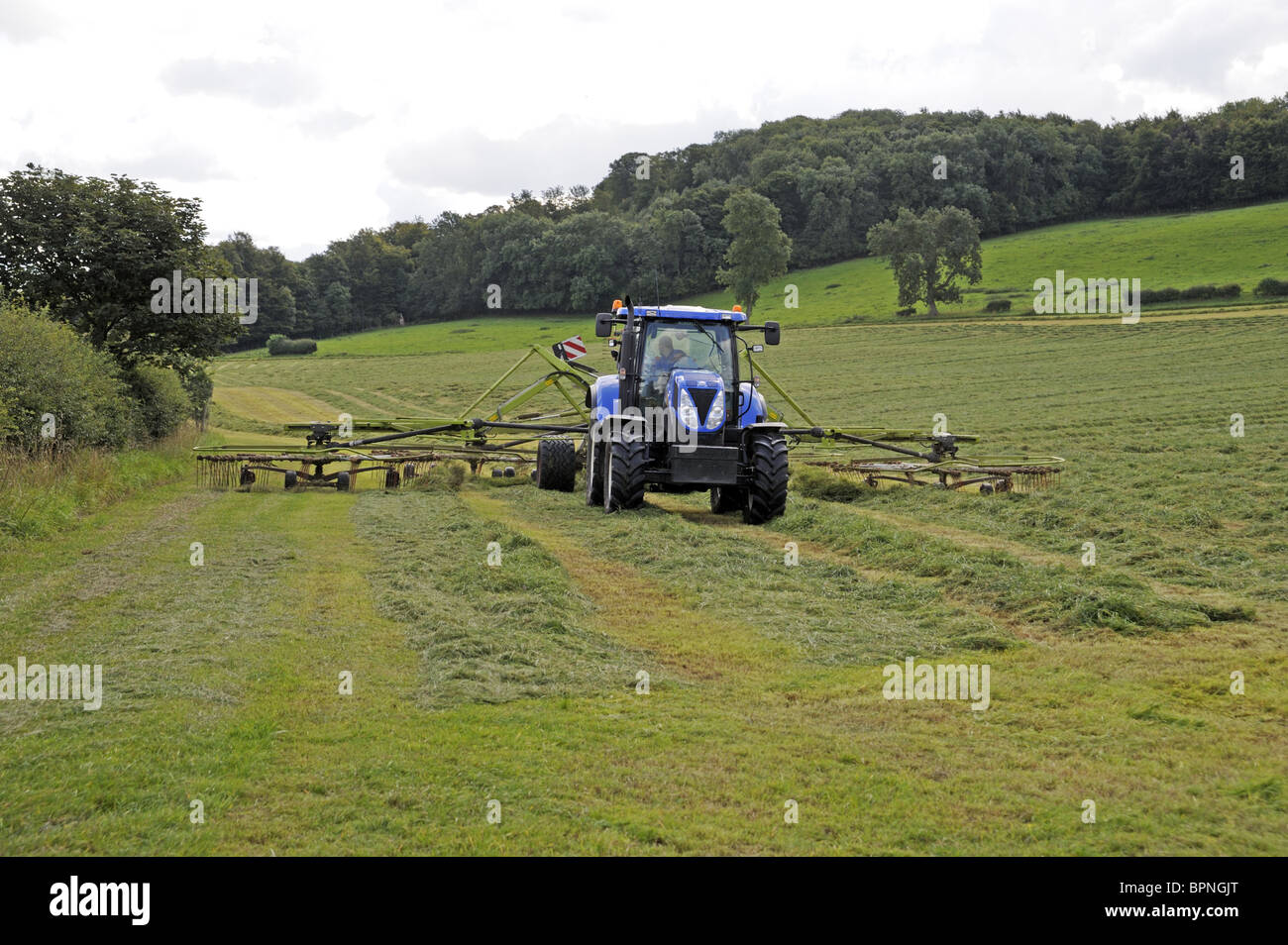 Tractor raking the hay, Yorkshire Stock Photo - Alamy