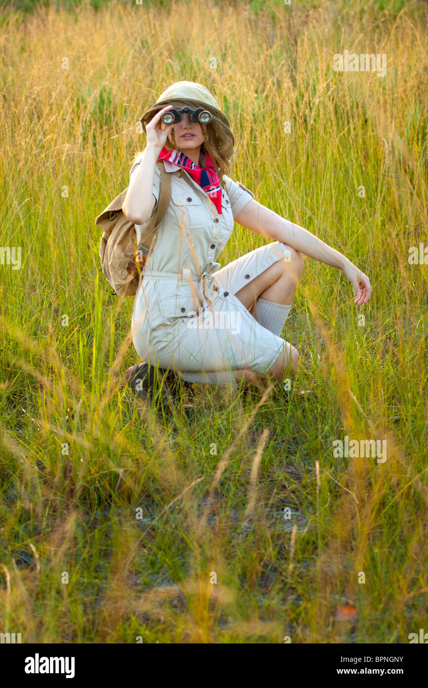 Woman using binoculars in Africa Stock Photo Alamy