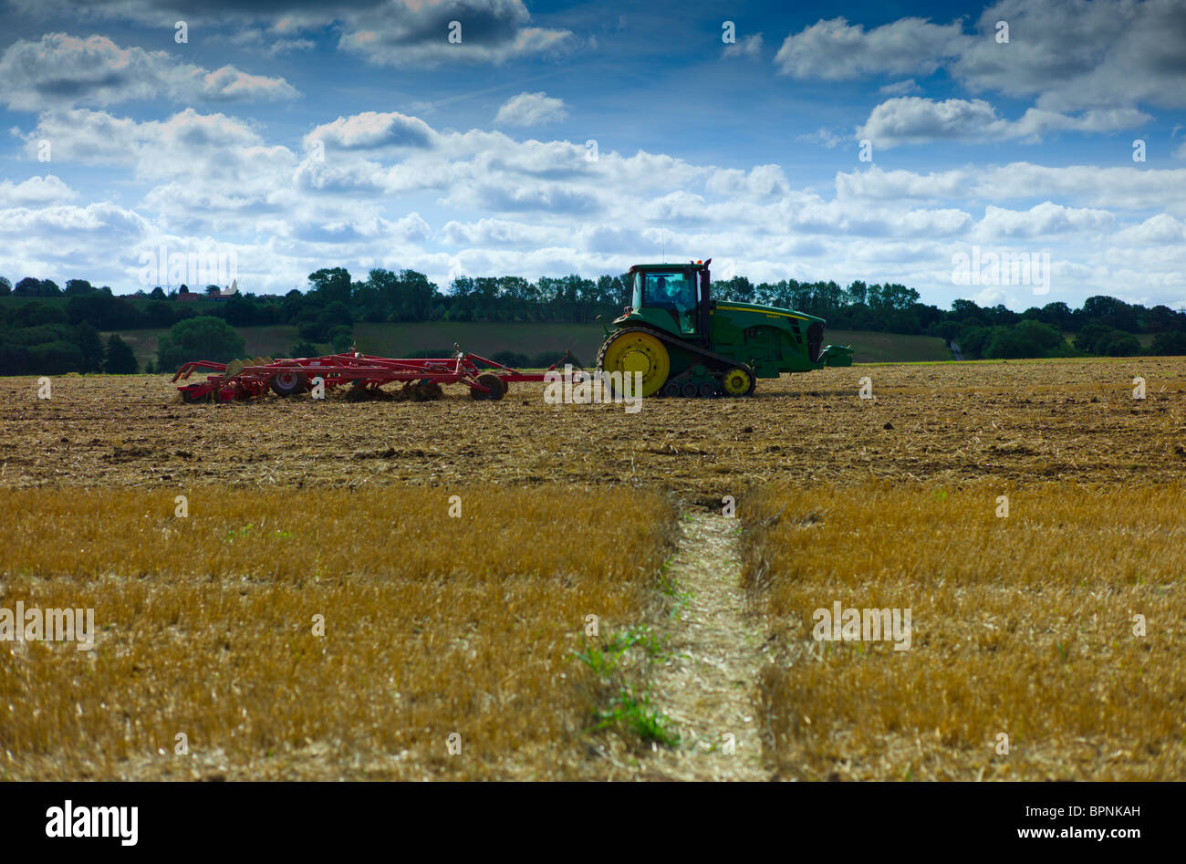 Tractor and plough ploughing a field in Kent Stock Photo Alamy
