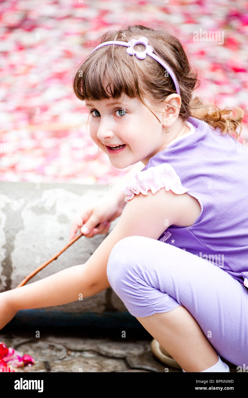 Cute little girl looking at a fountain hi-res stock photography ...