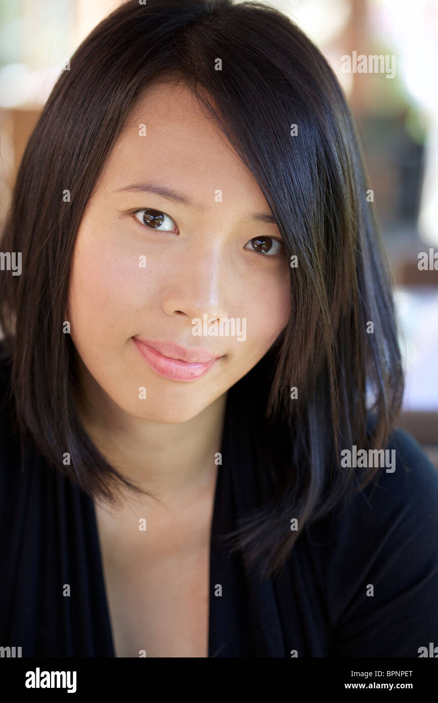 Portrait of a beautiful Asian woman smiling in front of the camera Stock Photo