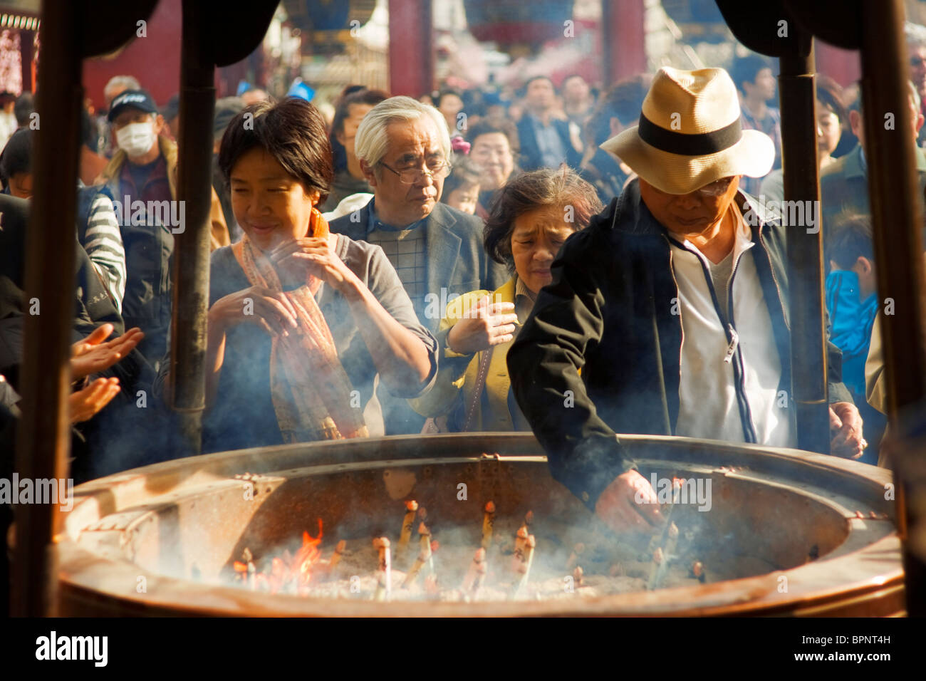 Japanese people place incense sticks in in Sensōji Buddhist Temple in